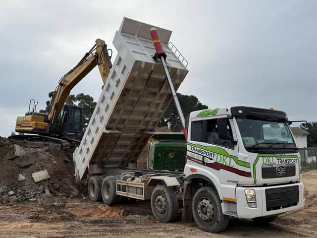 DKL excavator loading a FAW tipper truck