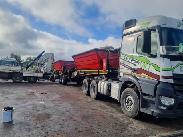 DKL Mercedes-Benz truck with red side-tipper trailers