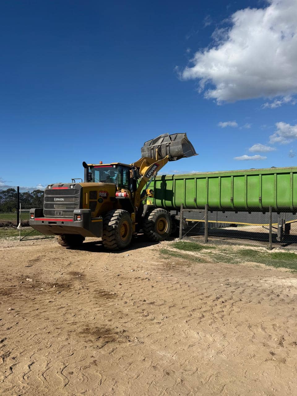 DKL wheel loader beside trailer