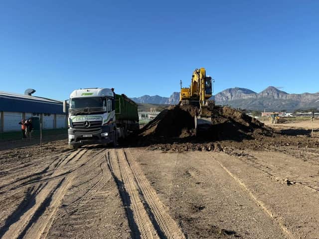 DKL Mercedes-Benz truck with excavator loading bulk material