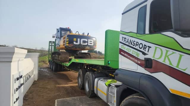 DKL lowbed transporting a JCB excavator